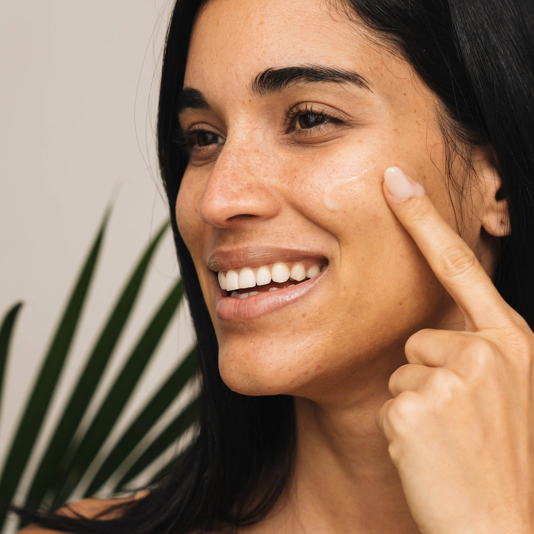 Woman applying product to her cheeks