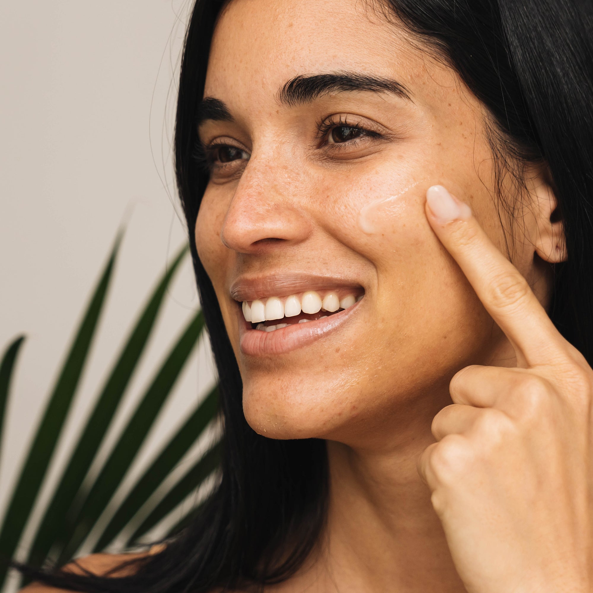 Woman applying product to her cheeks