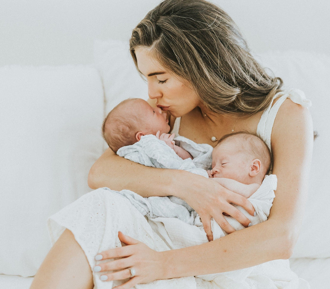 Jordan Harper holding her two newborn babies