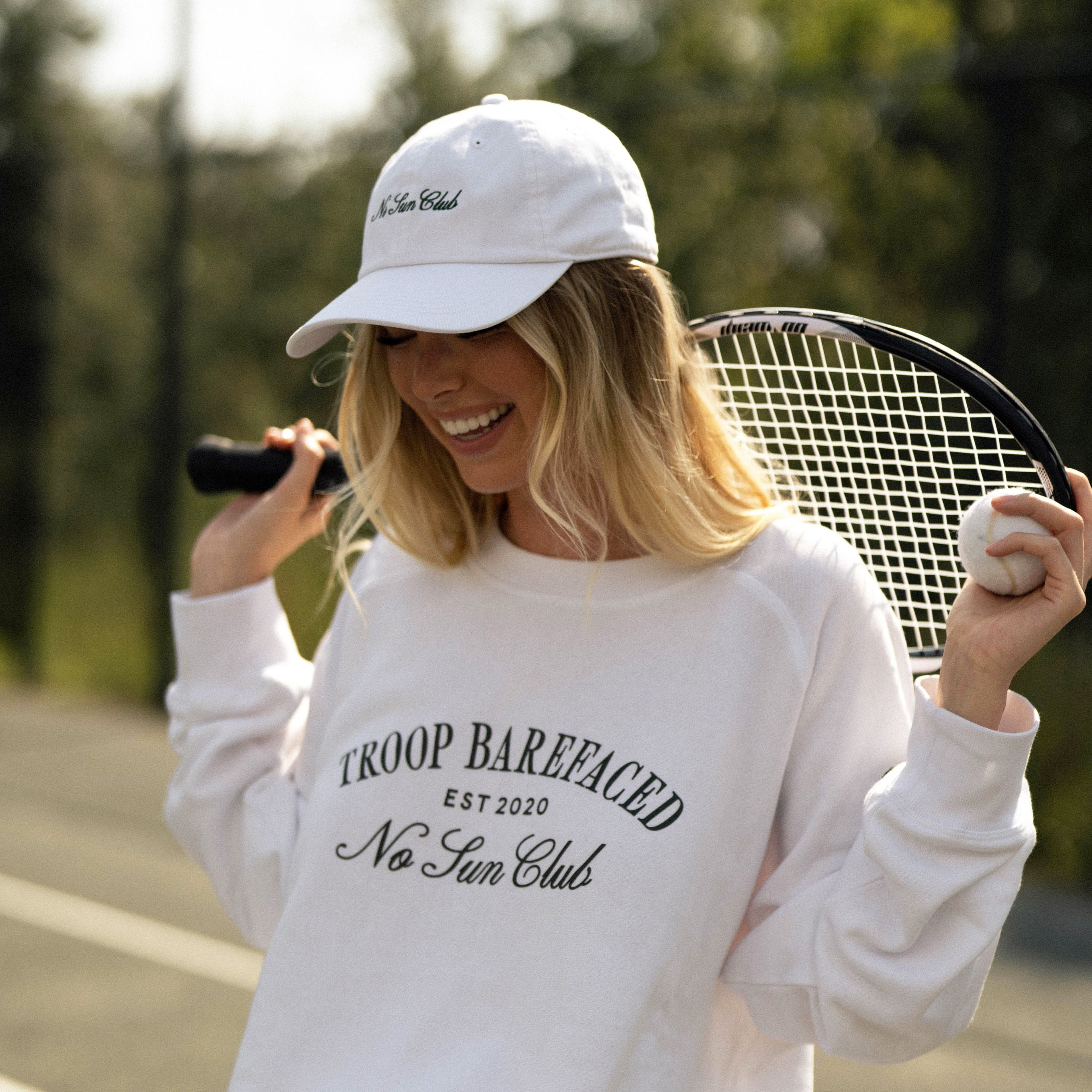 Woman wearing No Sun Club Dad Hat playing tennis