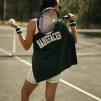 Woman wearing Barefaced Varsity Crewneck sweatshirt playing tennis