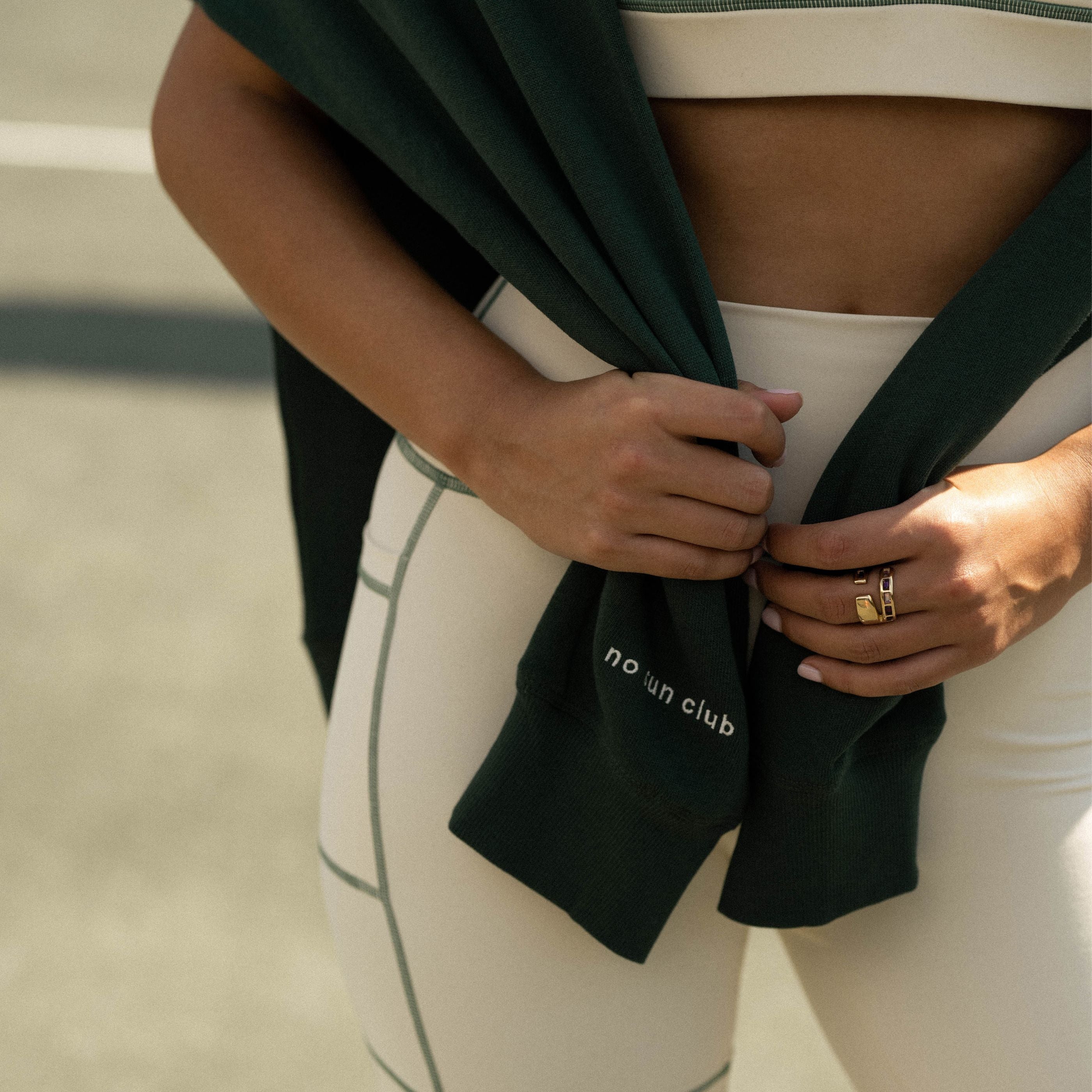 Close up of the Barefaced Varsity Crewneck sleeve that says "no sun club"