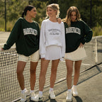 Three women wearing Barefaced sweatshirts