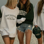 Women walking on the beach wearing Barefaced sweatshirts